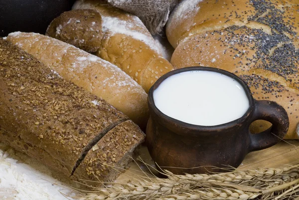 Pan, harina, cereales y una taza de leche . —  Fotos de Stock