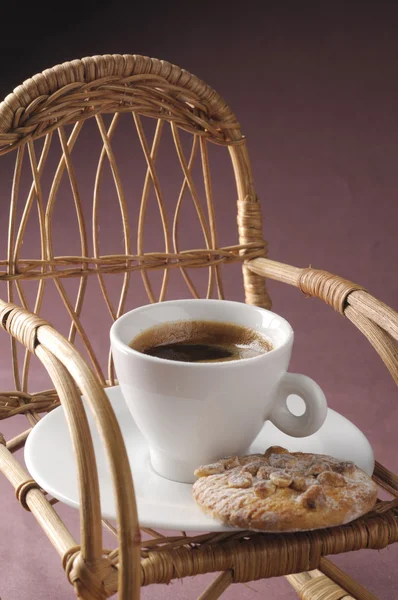 Coffee cup over rocking chair — Stock Photo, Image