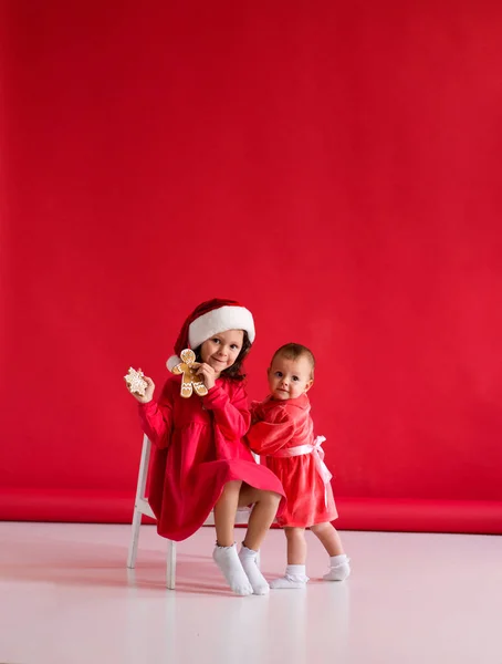 Дівчина Капелюсі Санта Різдвяними Пряниками Сестри Дві Дівчини Червоних Сукнях — стокове фото