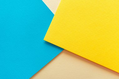 Soyut kağıt - renkli arkaplan, sarı, mavi ve bej, kağıt duvar kağıdından yaratıcı tasarım. Parlak doymuş geometri.