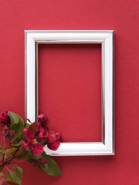 Güzel bir çiçek aranjmanı. Açık pembe çiçekler, boş fotoğraf çerçevesi kırmızı arkaplandaki mesajlar için. Düğün için. Doğum günü. Sevgililer Günü. Anneler Günü. Üst görünüm, boşluk kopyala