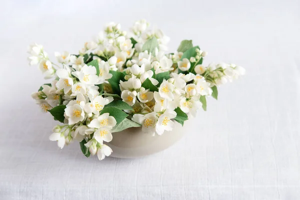 Beautiful flower arrangement. Jasmine flowers, free space for text on a light pastel background. Wedding, birthday. Valentine\'s day, mother\'s day. Top view, copy space