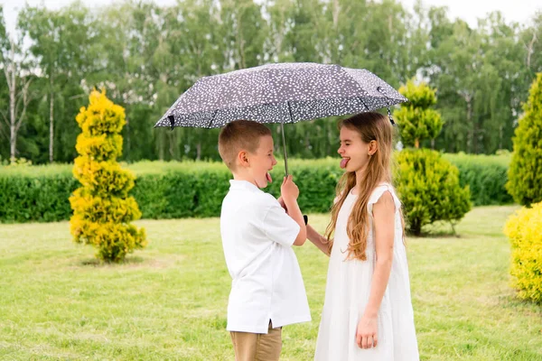Cheerful Children Umbrella Brother Sister Show Tongue Each Other Happy — Stockfoto