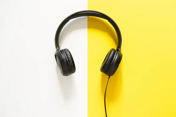 Hands Holding Headphones Bicolor Yellow White Background View Copy Space — ストック写真