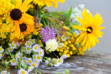 bouquet of wild flowers on rustic background, selective focus.