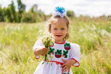 little girl in national Ukrainian clothes - vyshyvanka. Ukraine, child in nature