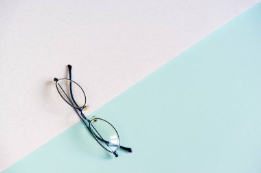 Beyaz mavi arka planda gözlük. Üst manzara, düz yatış. Optalmoloji günü