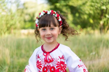 little girl in national Ukrainian clothes - vyshyvanka. Ukraine, child in nature