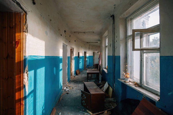 Dark dirty corridor of old abandoned building.