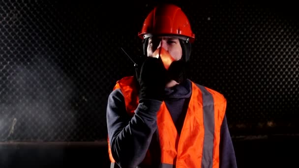 화재 당시 인공호흡기를 끼고 있는 남자가 산업 건물에서 워키토키에 대해 이야기하는 모습 — 비디오