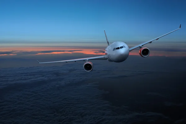 Flugzeug am Himmel bei Sonnenuntergang — Stockfoto