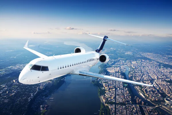 Private jet plane in the blue sky Stock Picture