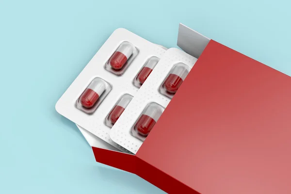 Cápsulas em caixa vermelha — Fotografia de Stock