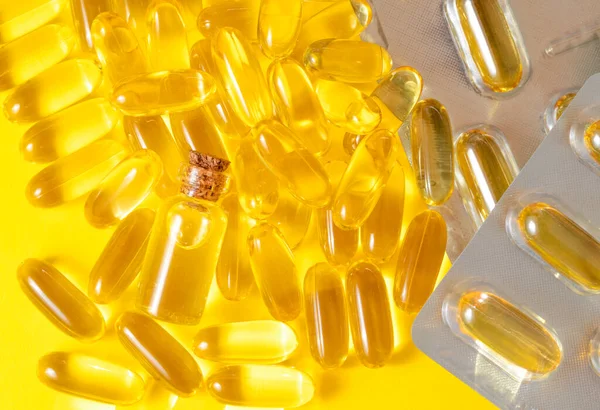 Some Omega-3 Fatty Acids Pills On Yellow Background
