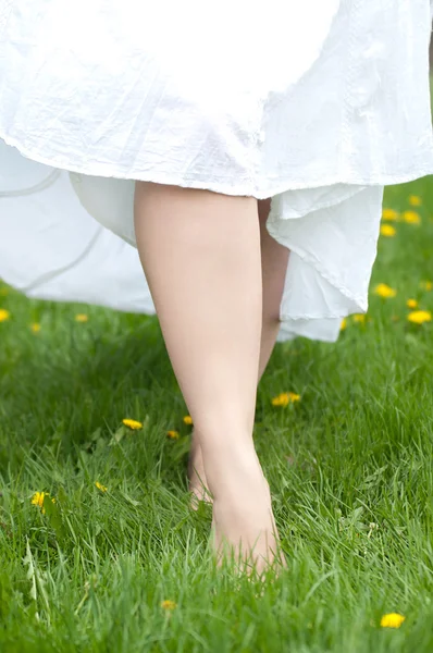 Γυναίκες γυμνά πόδια συνεχίζεται η χλόη της άνοιξης — Φωτογραφία Αρχείου