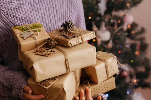 Females hands in pullover holding many gift boxes. — Stock Photo, Image