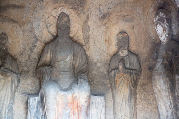 Famous Longmen Grottoes (statues of Buddha and Bodhisattvas carved in the monolith rock near Luoyang in Hennn province, China)