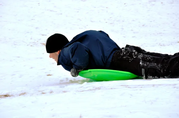 Boy sleds on stomach — Stock Photo, Image