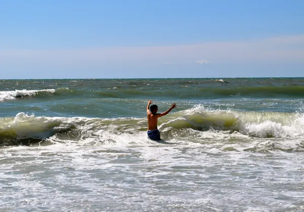 Teen playing in waves Royalty Free Stock Photos