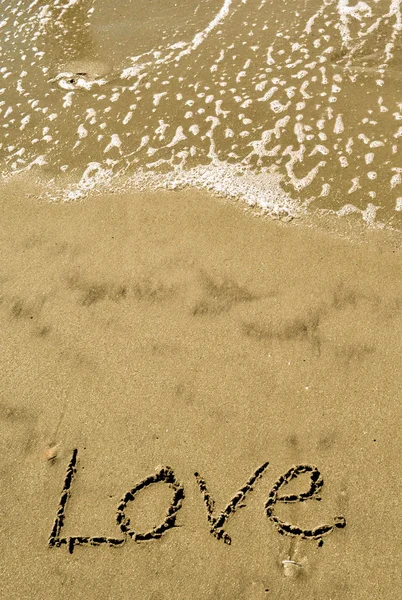 Love written in the sand with wave 14-1 — Stock Photo, Image