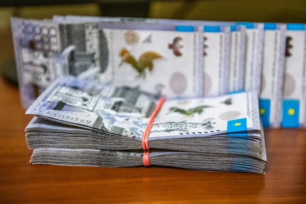 Thick wad of money cash on table. High quality photo