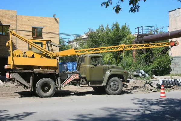 Mobile Crane on a road and tower crane in construction site