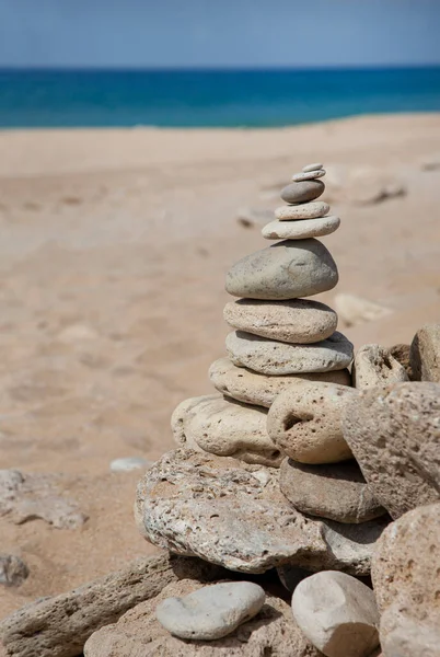 Balances stone cairn on one of Spains sunny beaches in Andalusia, perfect for a greeting card, gift bag or calendar image
