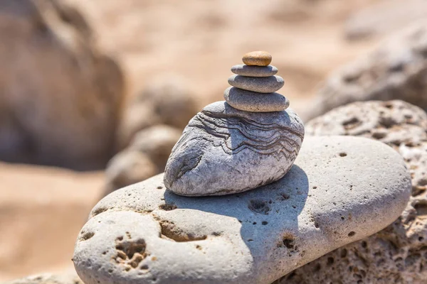 Balances stone cairn on one of Spains sunny beaches in Andalusia, perfect for a greeting card, gift bag or calendar image