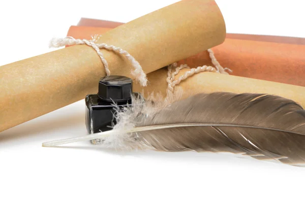 A feather pen, ink,rolls of old yellowed paper — Stock Photo, Image