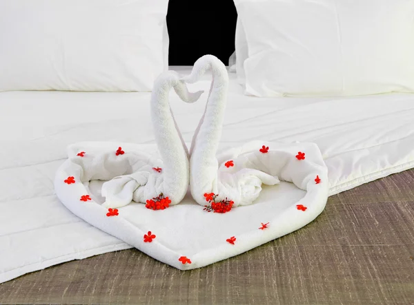 Cameră într-un hotel cu lebede de la prosop pe patul proaspăt căsătorit — Fotografie, imagine de stoc