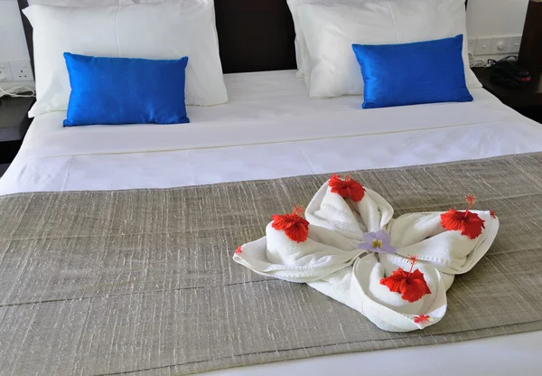 Quarto em um hotel com uma decoração da toalha e flores no th — Fotografia de Stock