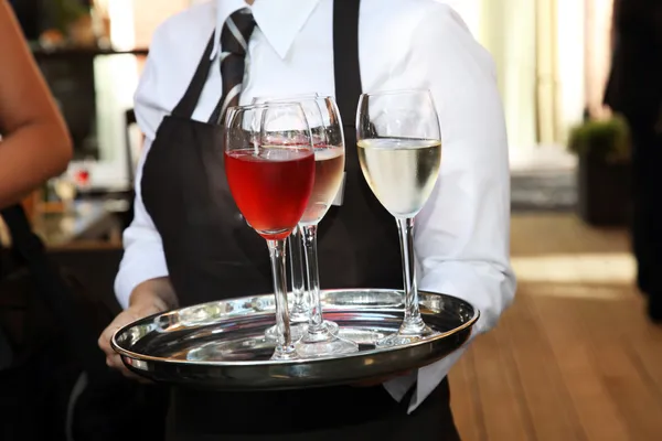 Waiter carrying wine glasses — Stock Photo, Image