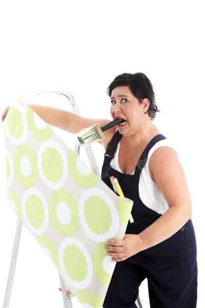 Exasperated woman hanging wallpaper Exasperated woman hanging wallpaper — Stock Image Exasperated woman hanging wallpaper Exasperated woman hanging wallpaper Stock Image