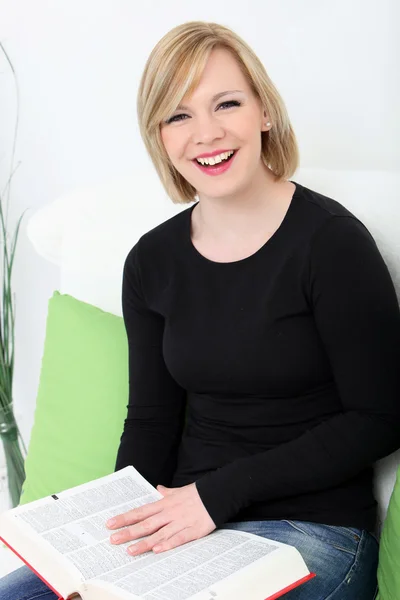 Laughing woman enjoying a book — Stock Photo, Image