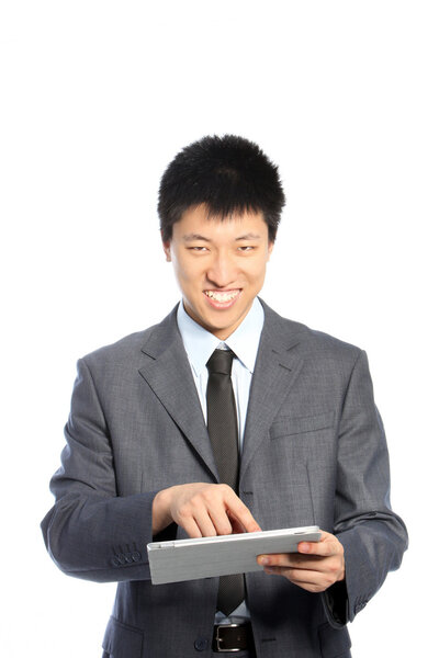 Smiling Asian young businessman using a PC tablet