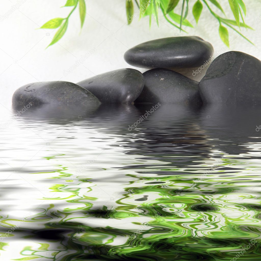 Black basalt spa stones in water