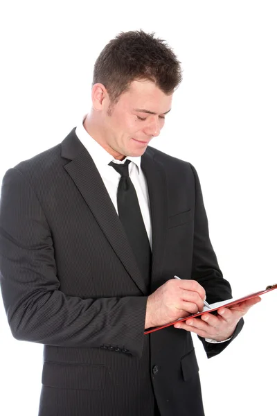 Businessman writing notes on a clipboard Royalty Free Stock Photos