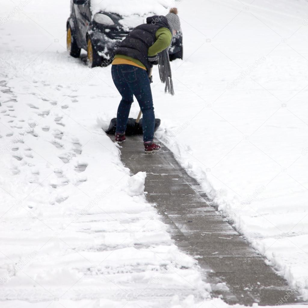 Person clearing snow off a pathway