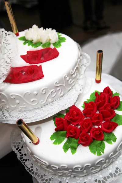 Gâteau de mariage décoré avec des roses rouges — Photo