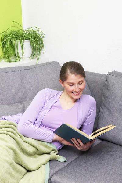 Mulher feliz lendo um livro — Fotografia de Stock