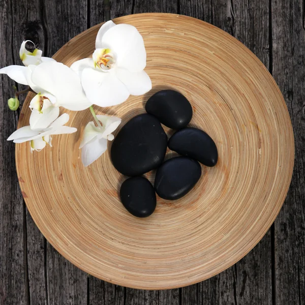 Massage stones in a pottery bowl — Stock Photo, Image