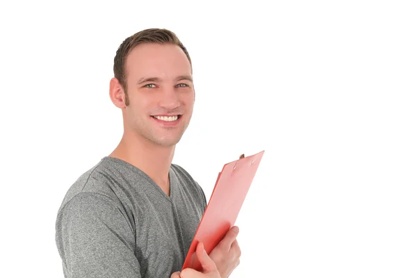 Guapo hombre sonriente sosteniendo un portapapeles — Foto de Stock