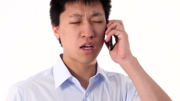 Young Asian man talking on smartphone, closeup — Stock Video
