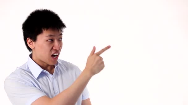 Funny Asian man pointing on a white copy space — Stock Video