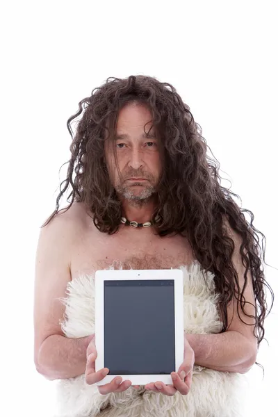 Funny primitive man holding a PC tablet — Stock Photo, Image