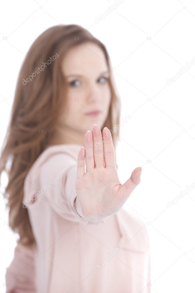 Young woman giving a Stop gesture