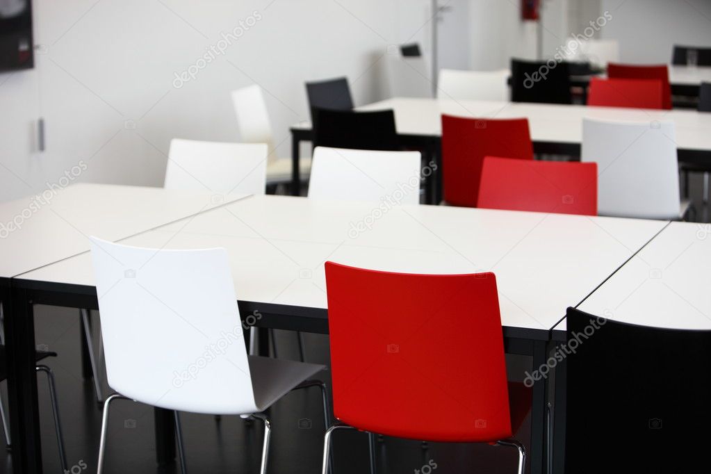 Empty red and white tables and chairs