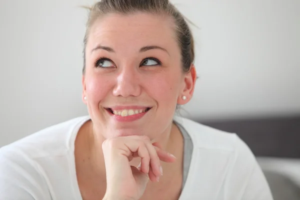 Beautiful smiling woman daydreaming — Stock Photo, Image