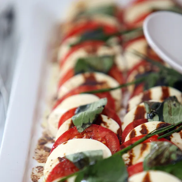 Display of mozzarella cheese and tomato — Stock Fotó