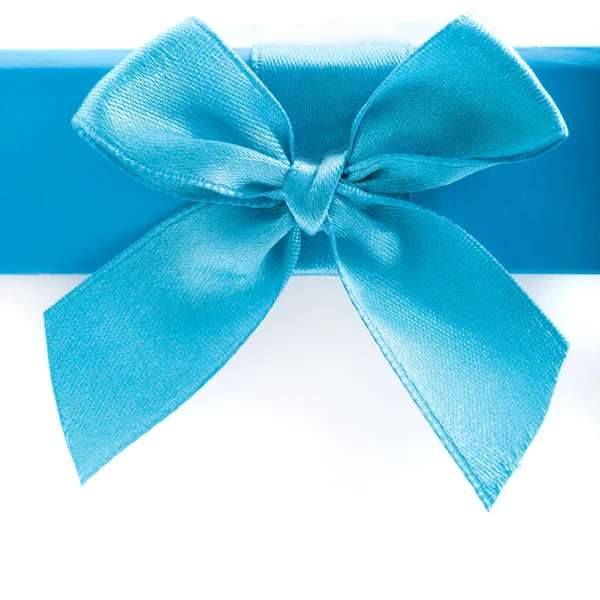Pretty blue bow and ribbon on a gift box lid Stock Image